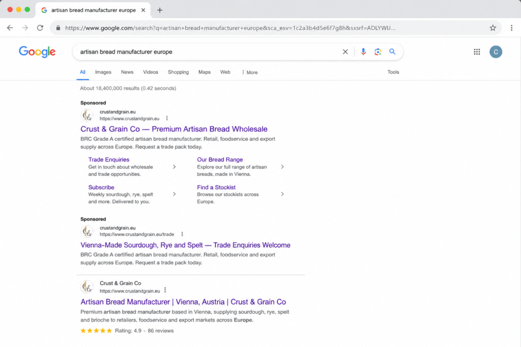 Google search results showing Crust & Grain Co paid search ads targeting artisan bread manufacturer Europe with trade wholesale and subscription sitelinks and organic position 1 result