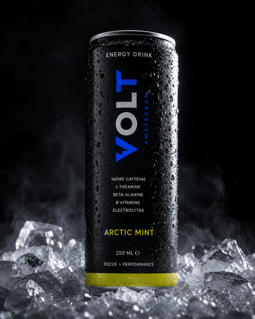 Photorealistic VOLT Arctic Mint energy drink can resting on crushed natural ice with mist rising condensation on metal surface cobalt logo and acid yellow accent band lit by single directional side light against deep black background