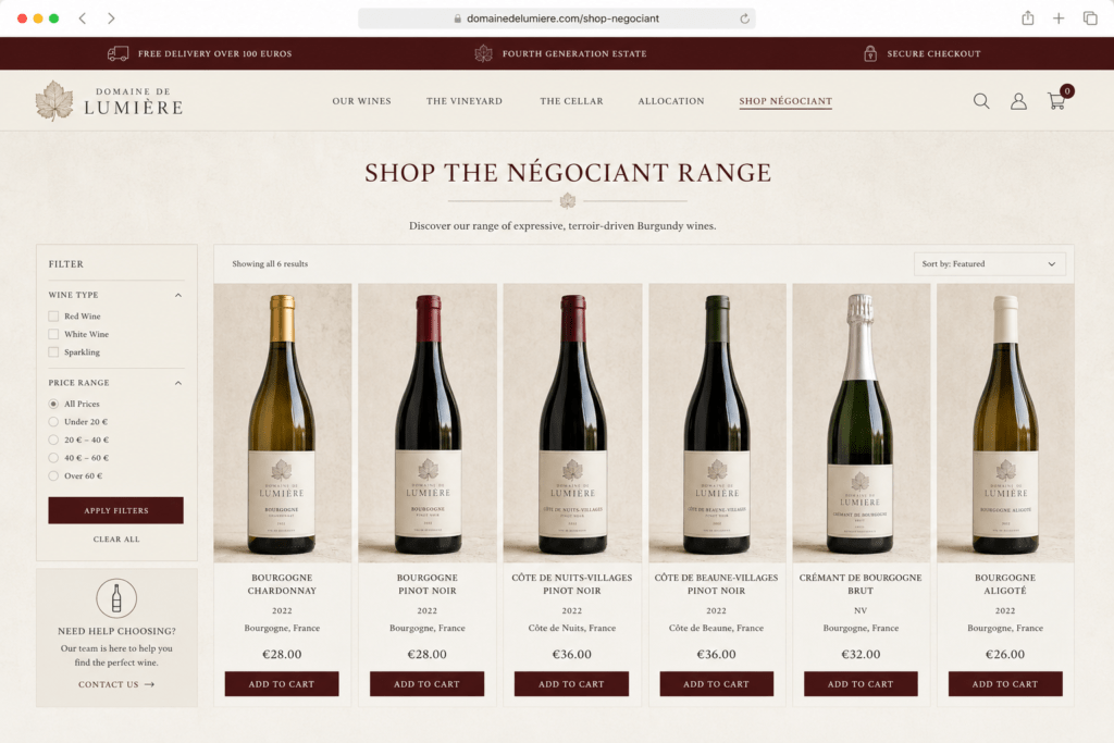 Domaine de Lumière e-commerce shop page on desktop showing six négociant wine product cards with bottle photography names vintages prices filter sidebar and add to cart buttons in limestone cream and Burgundy red